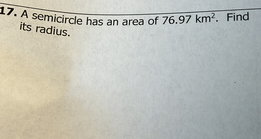 17. A semicircle has an area of \( 76.97 \mathrm{~km}^{2} \). Find its radius.